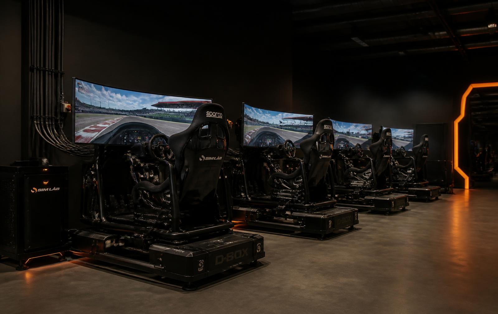 Row of commercial motion racing simulators in a venue installation
